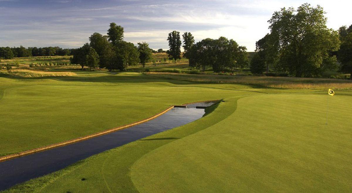 Smooth being separated by a water hazard running through the course.
