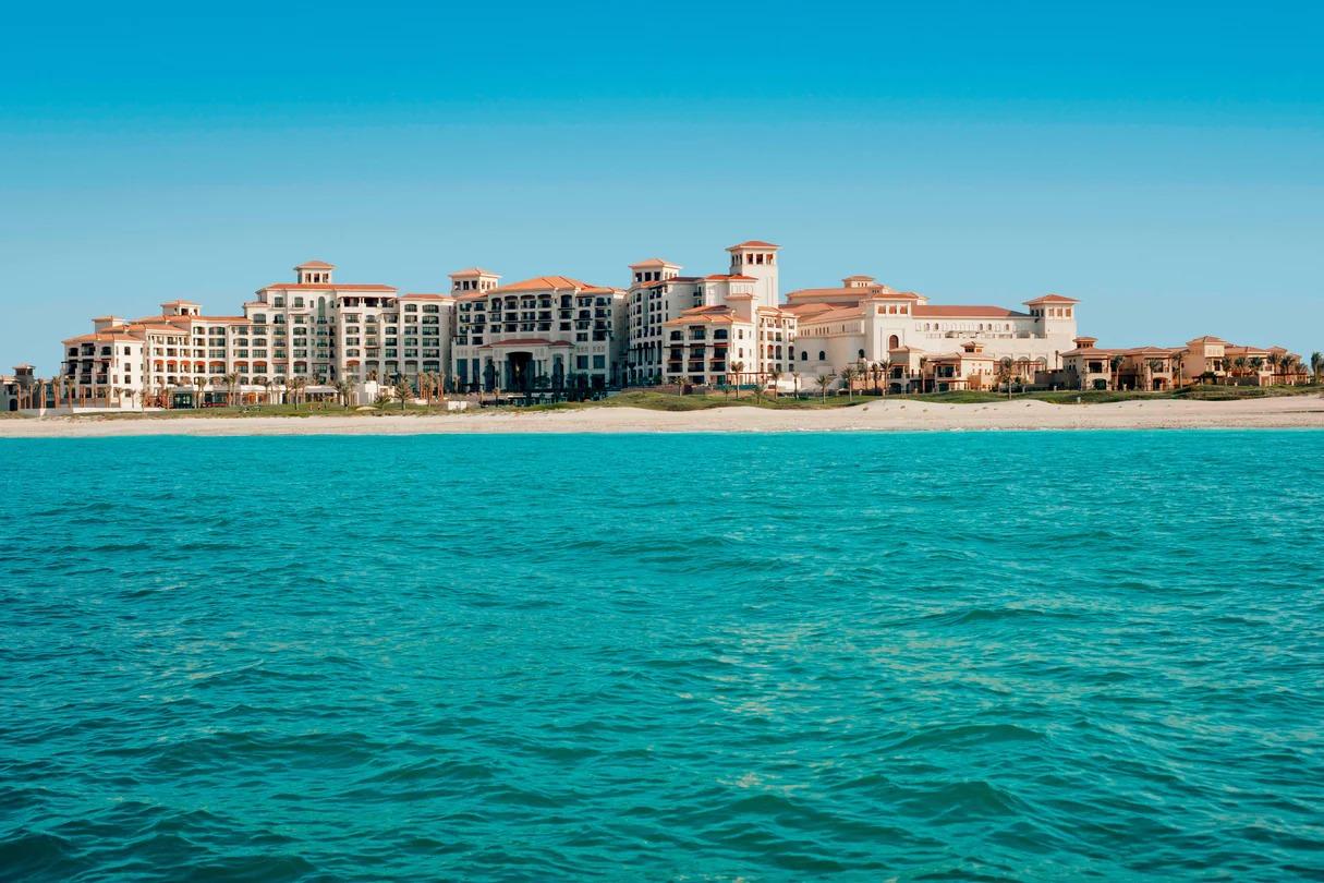 The St. Regis Saadiyat Island Resort looking over the beach under clear blue skies