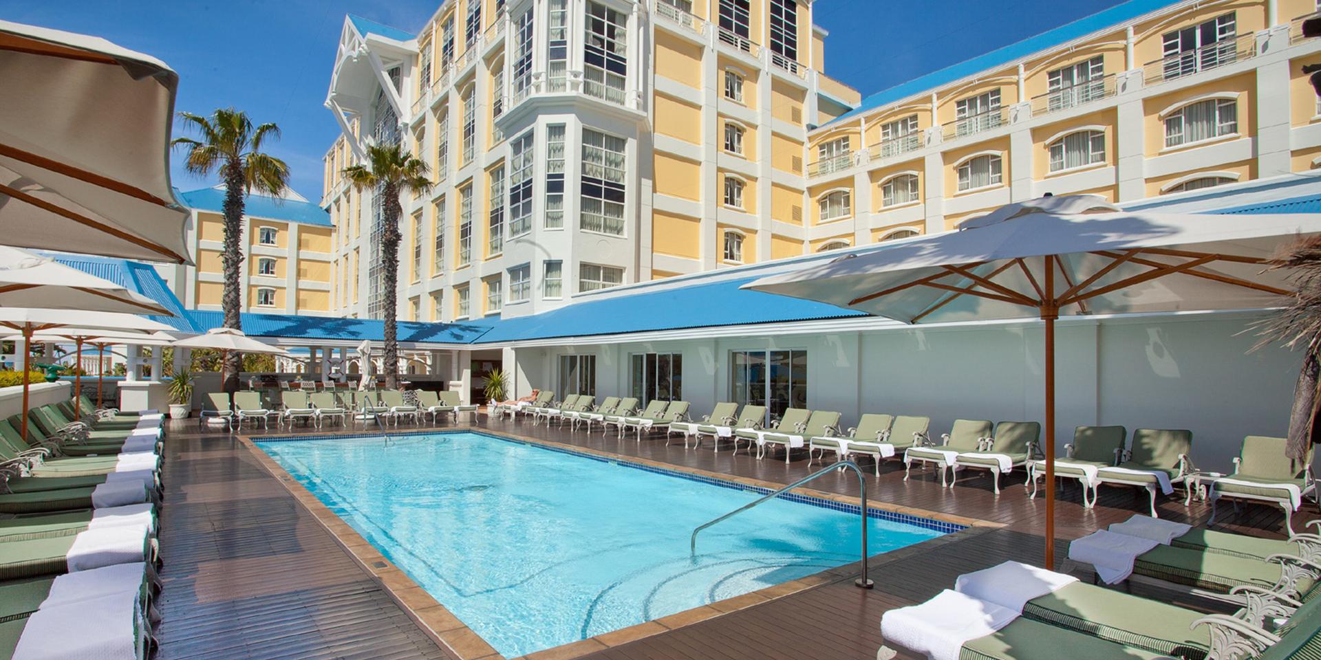 Outdoor swimming pool at The Table Bay Hotel surrounded by sunbeds