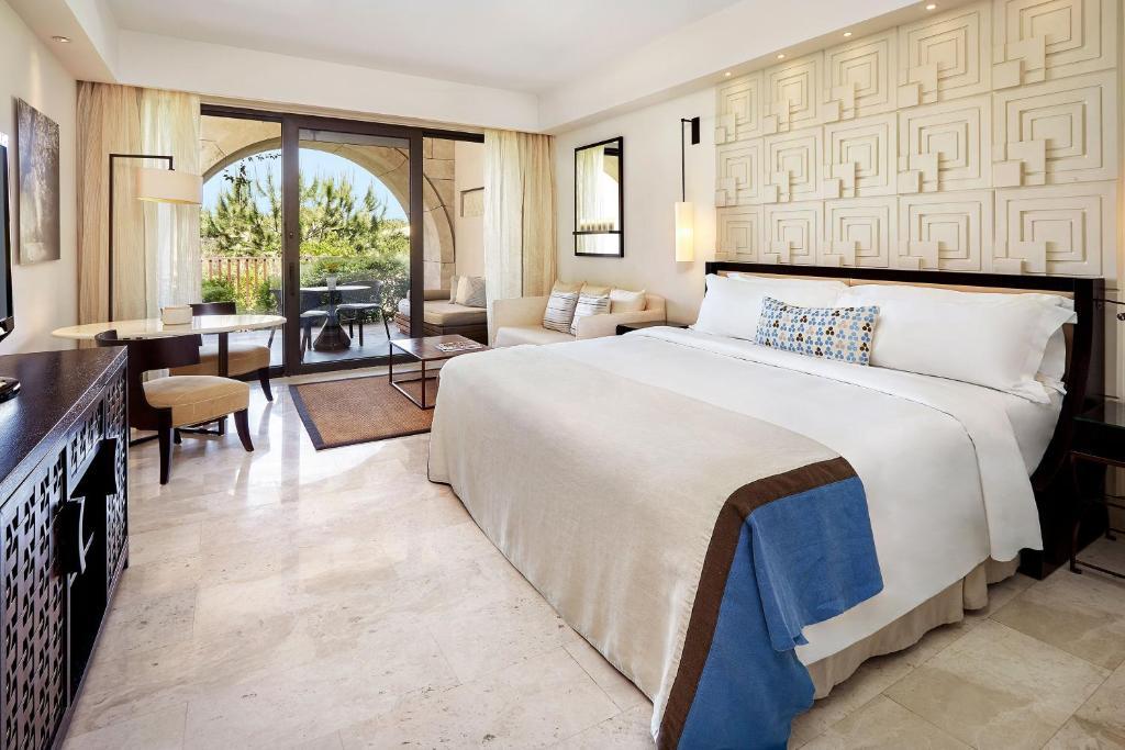 Spacious double bed room at the hotel with indoor and balcony seating