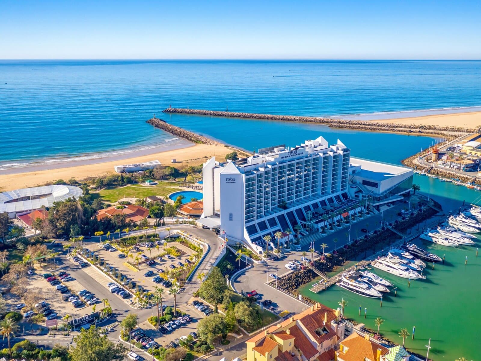 Aerial view of the hotel with the marina and beach visible