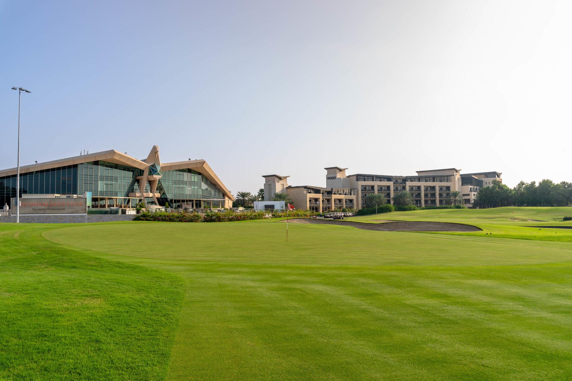 The VOGO clubhouse and resort building overlooking a smooth green on the golf course