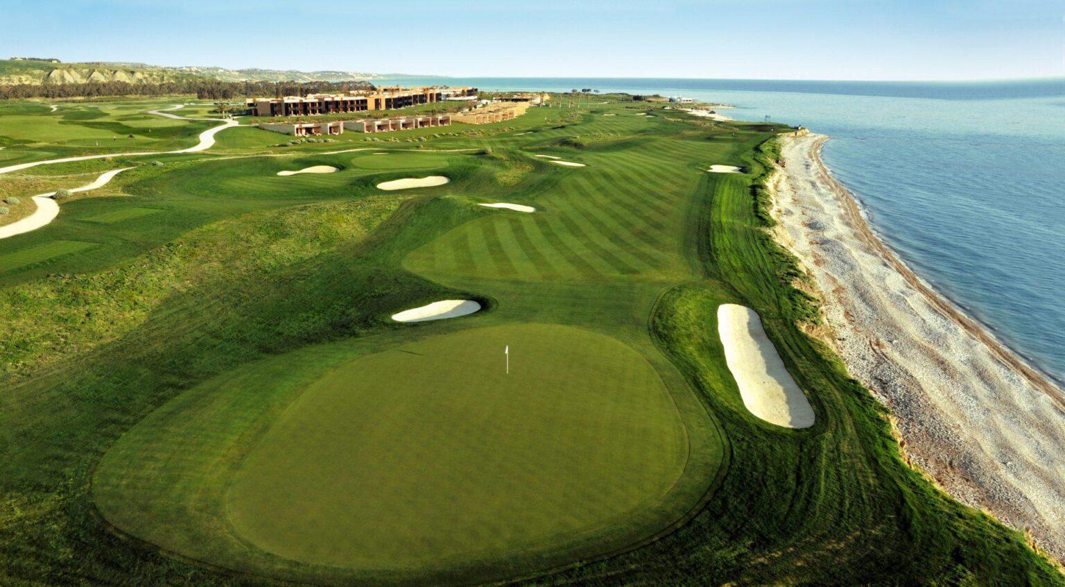Scenic golf course stretching along the coastline with rolling fairways and sand bunkers.