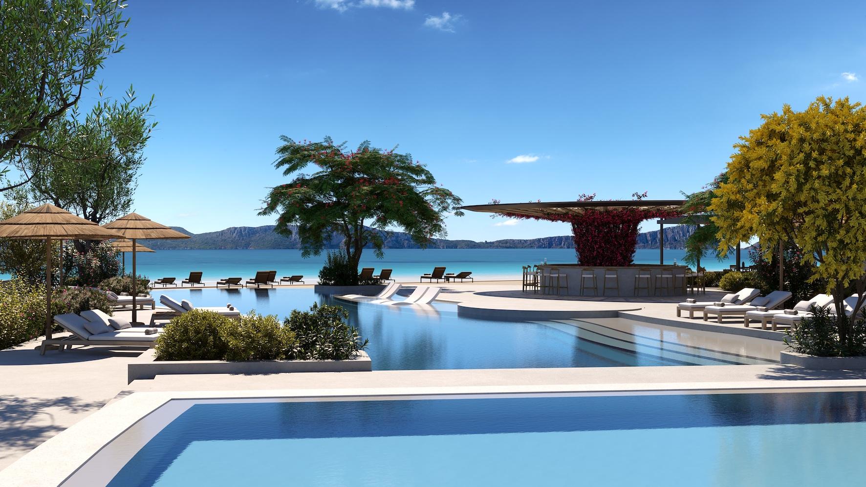 A seaside swimming pool at the hotel featuring an outdoor bar under blue skies