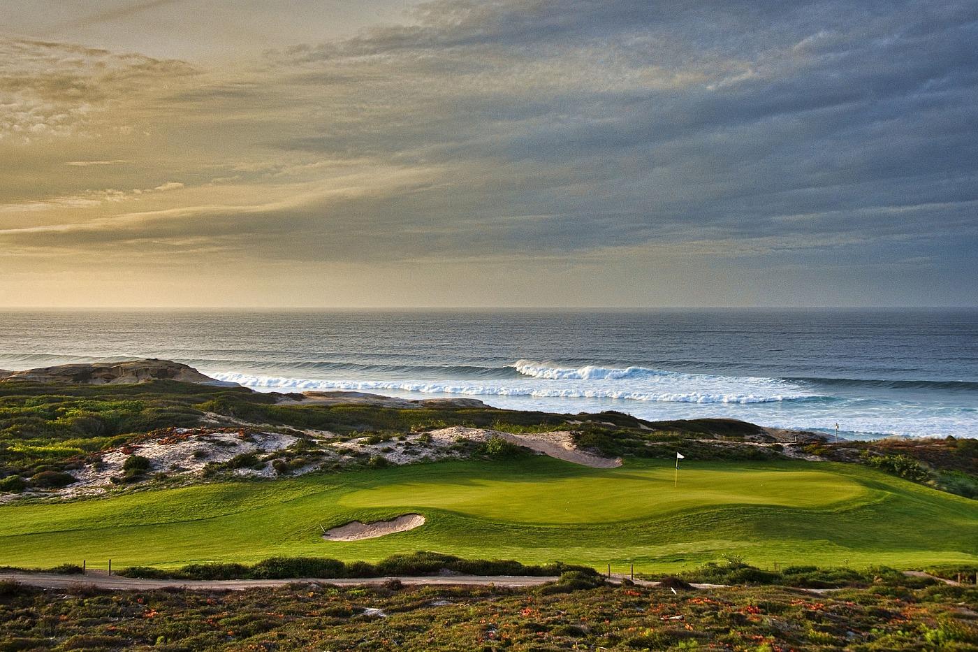 Undulating green with the ocean behind