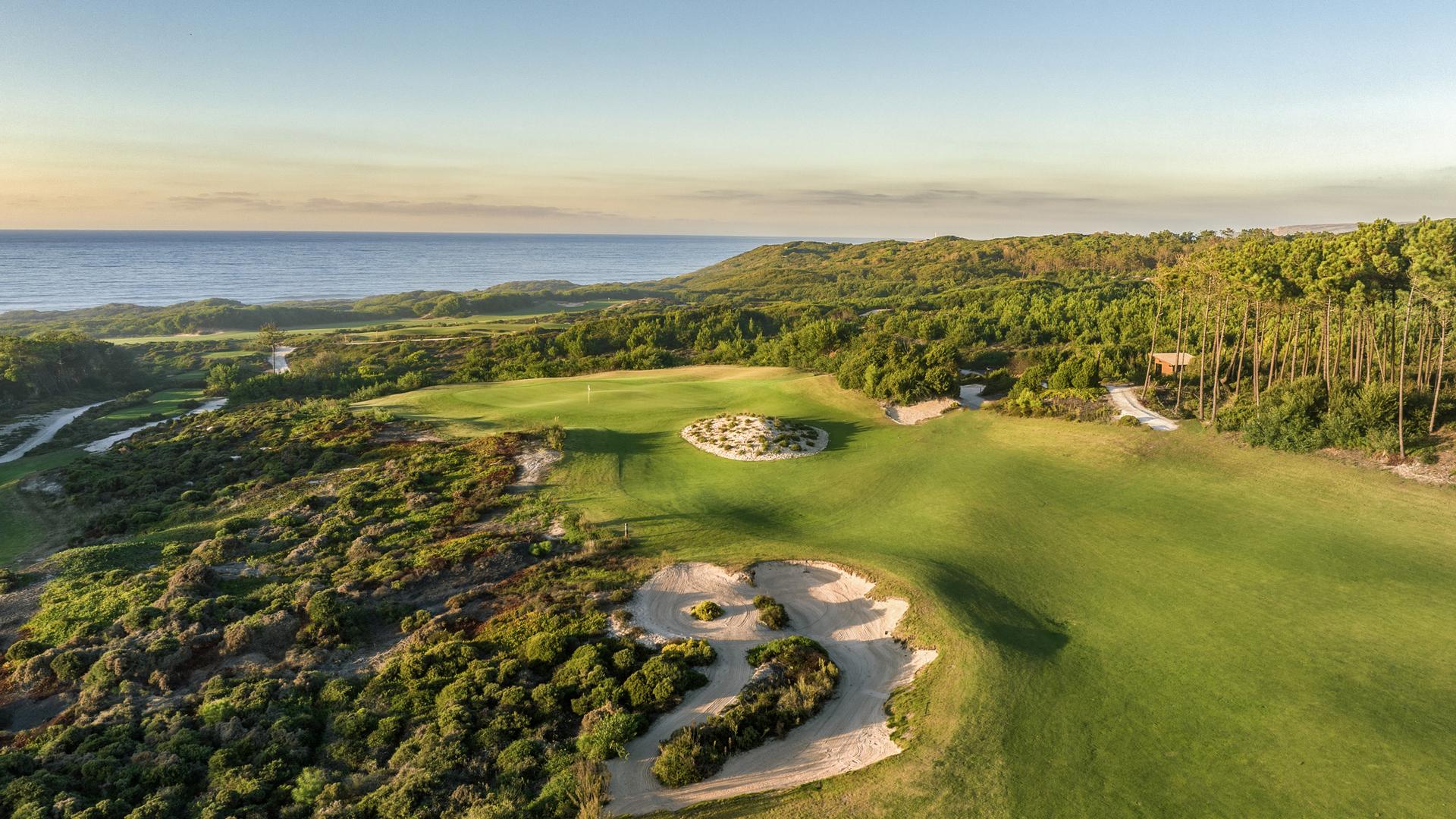 Undulating fairway leading to a sloping green with a bunker in front