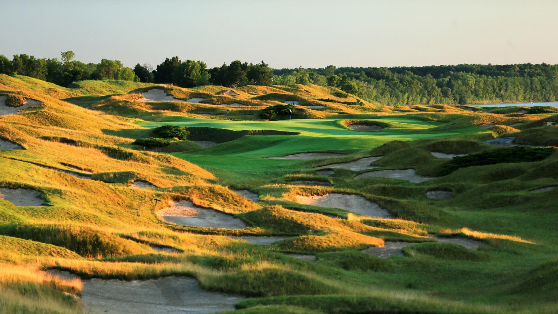 Countless small sand bunkers nestled into the surrounding rough and two large ones on the green