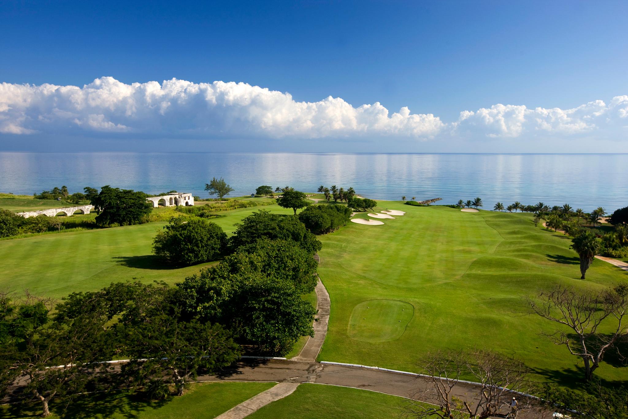 The course offers stunning ocean views with wide fairways and lush greenery.