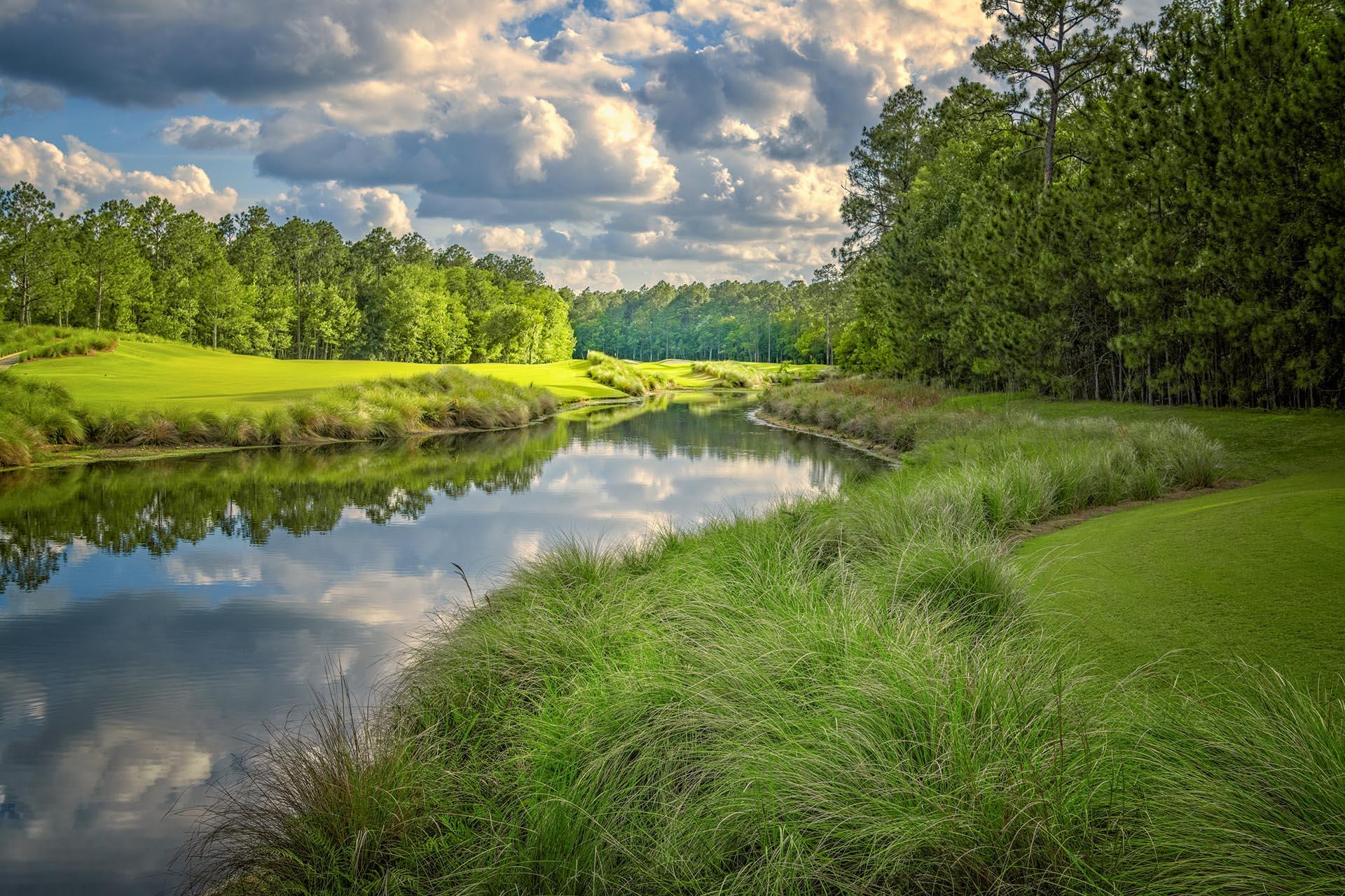 Serene water hazard running through the course sandwiched by well maintained fairways