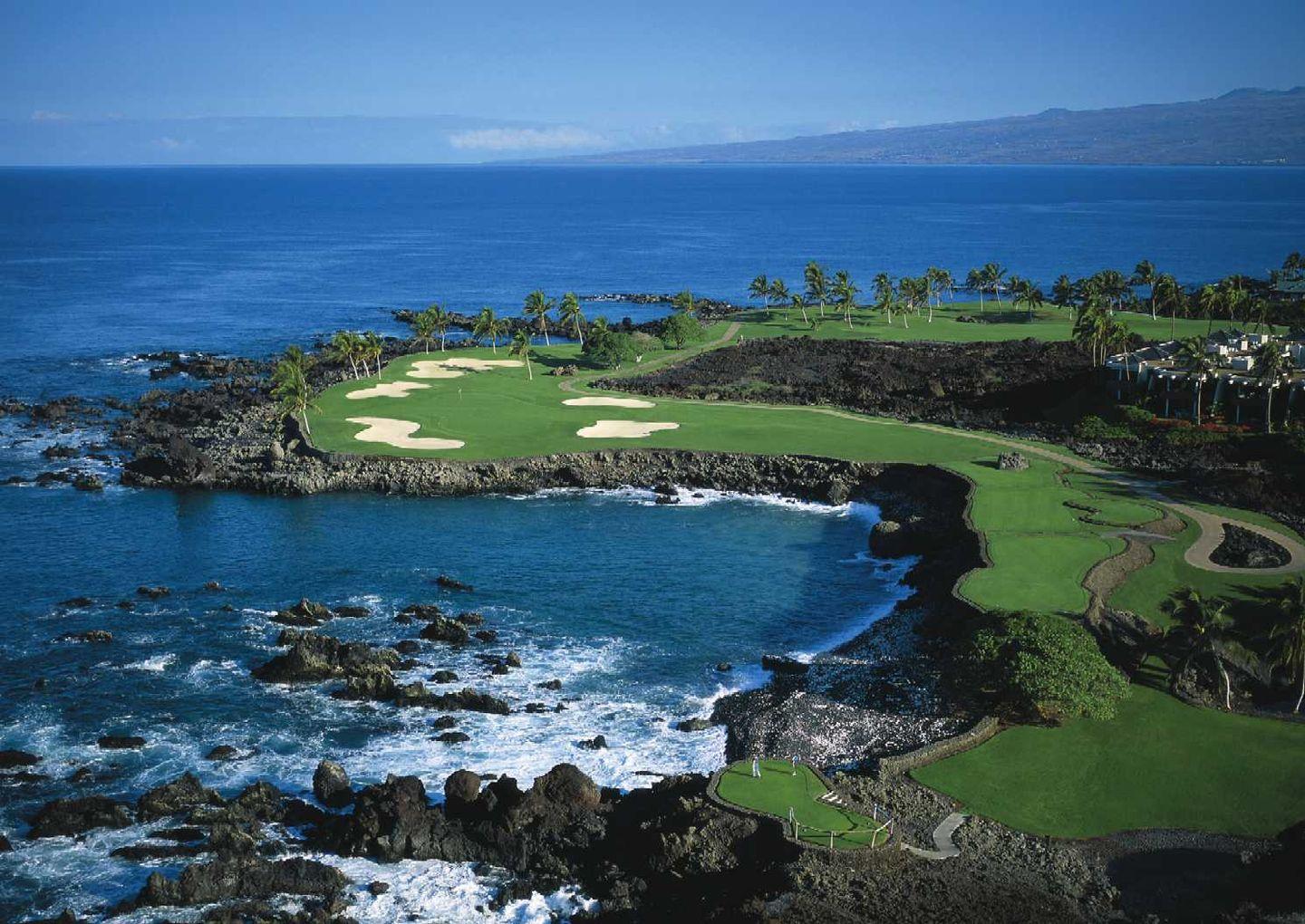 Aerial view od a winding, cliffside fairway