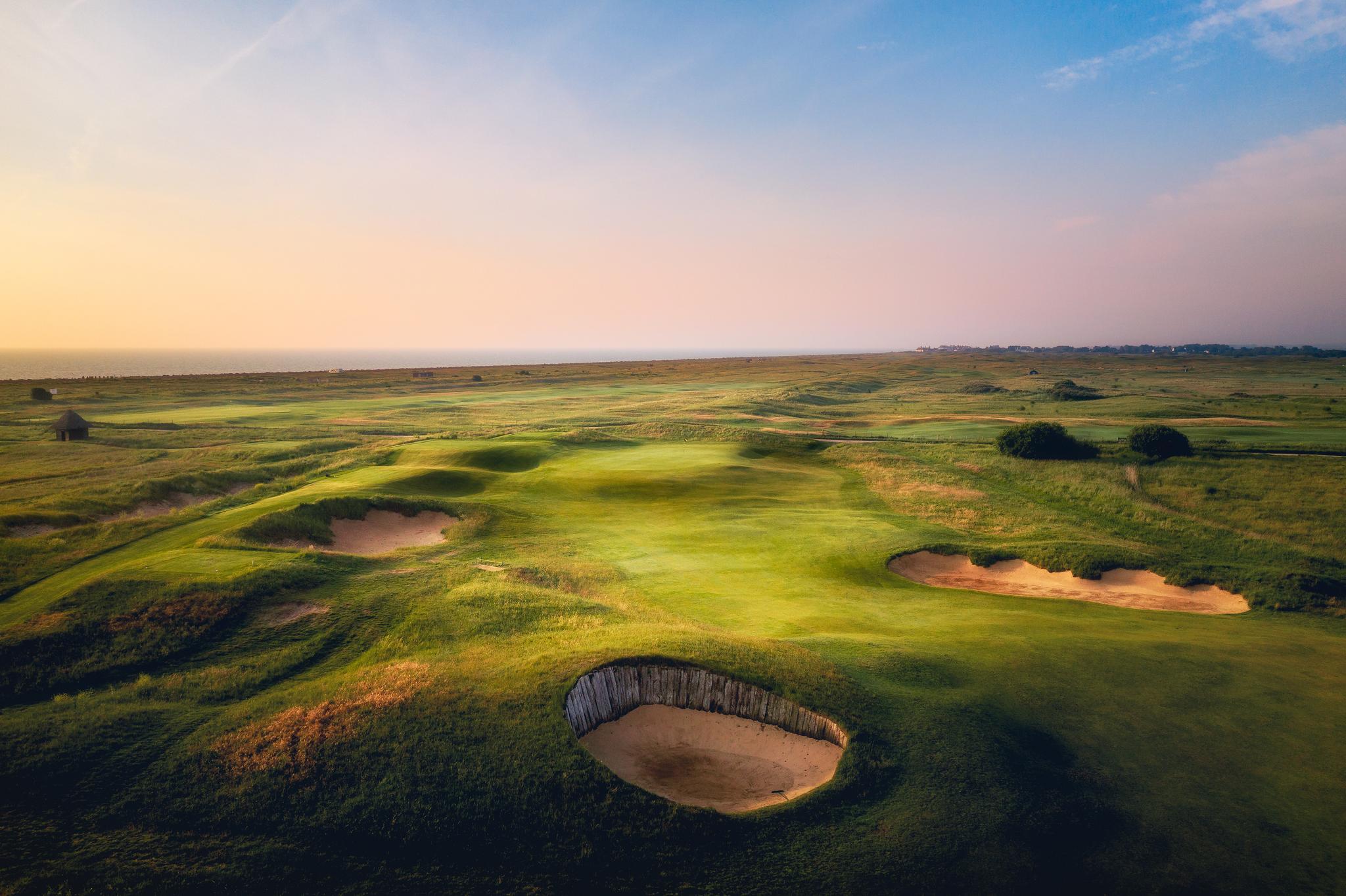 Overhead view of a well maintained fairway nestled with sand bunkers
