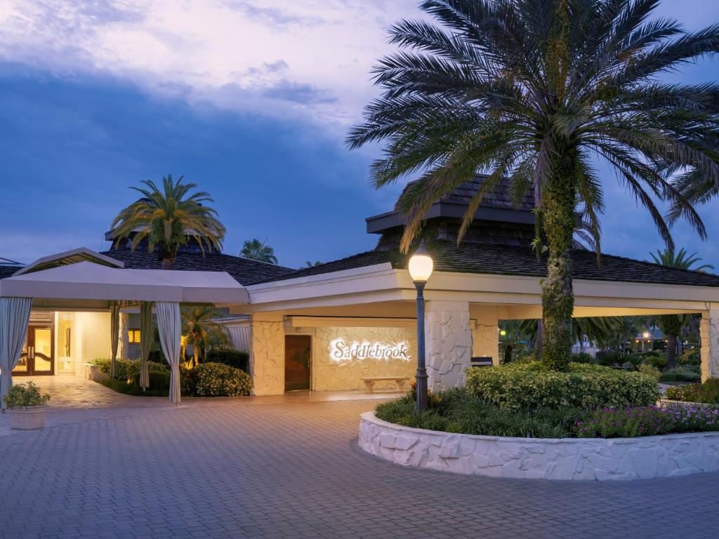 Front entrance to the saddlebrook resort with their sign illuminated on the wall