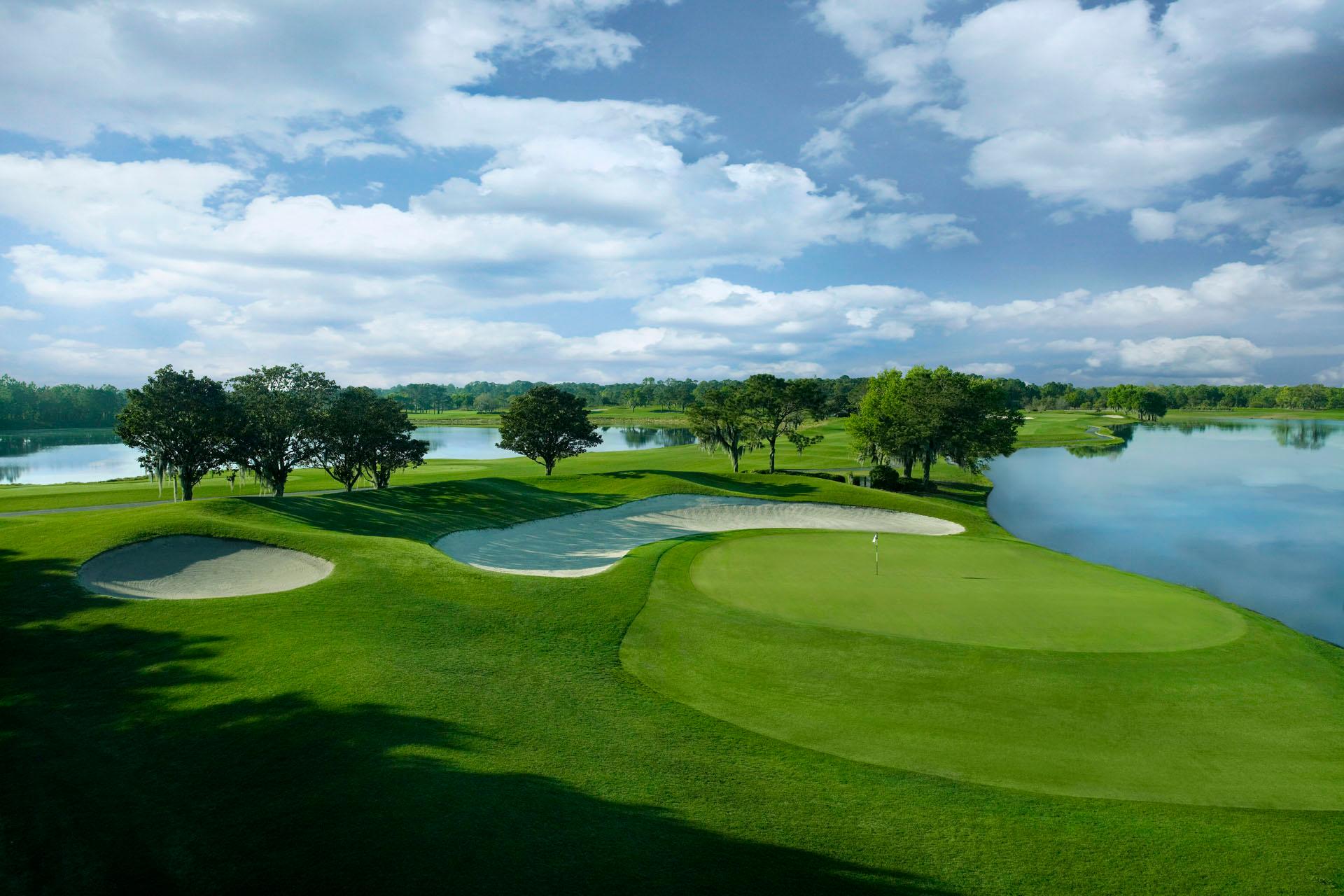 Tight fairway with water on both sides leading to a manicured green