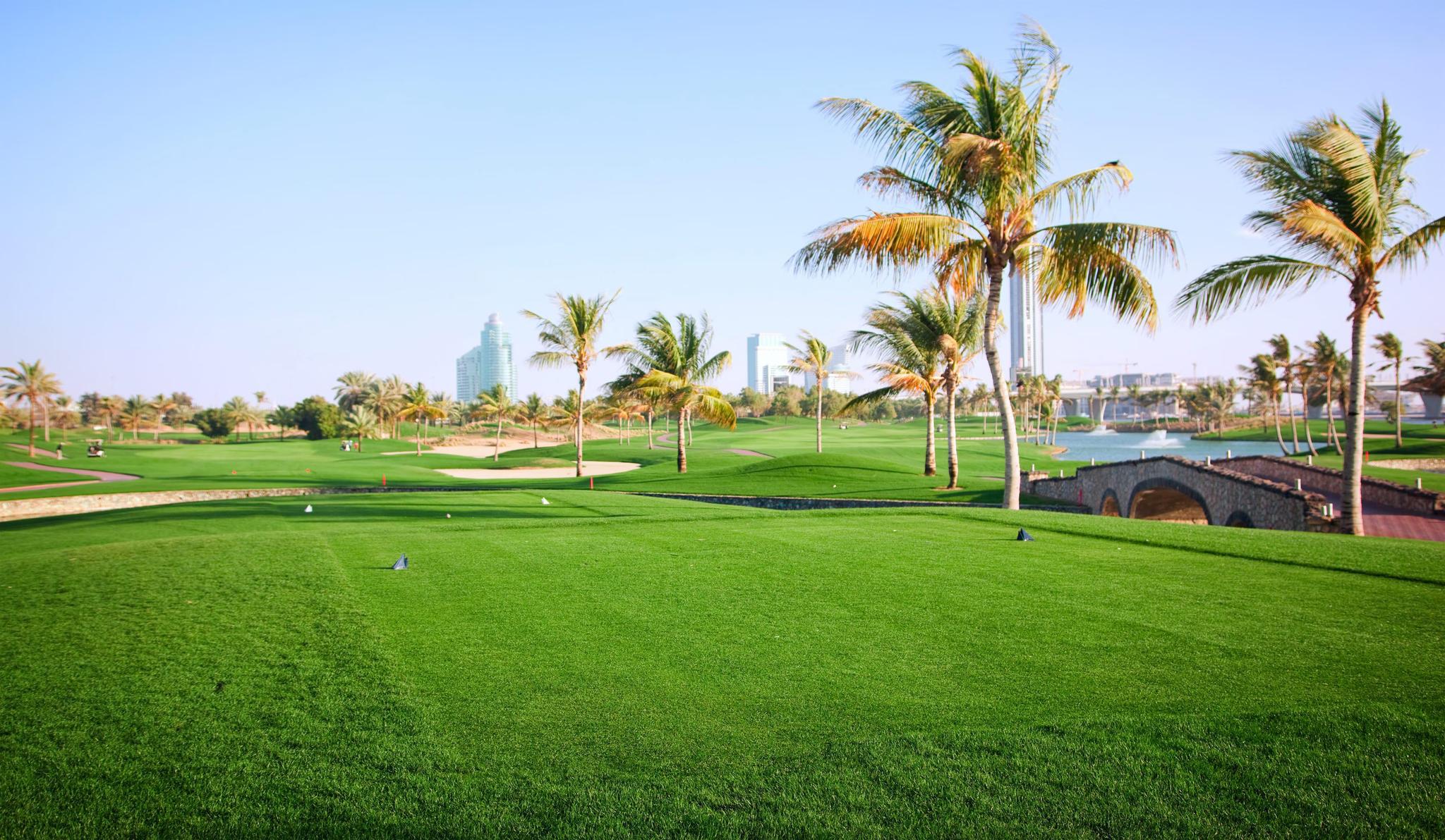 Well maintained fairways nestled with sand bunkers and palm trees