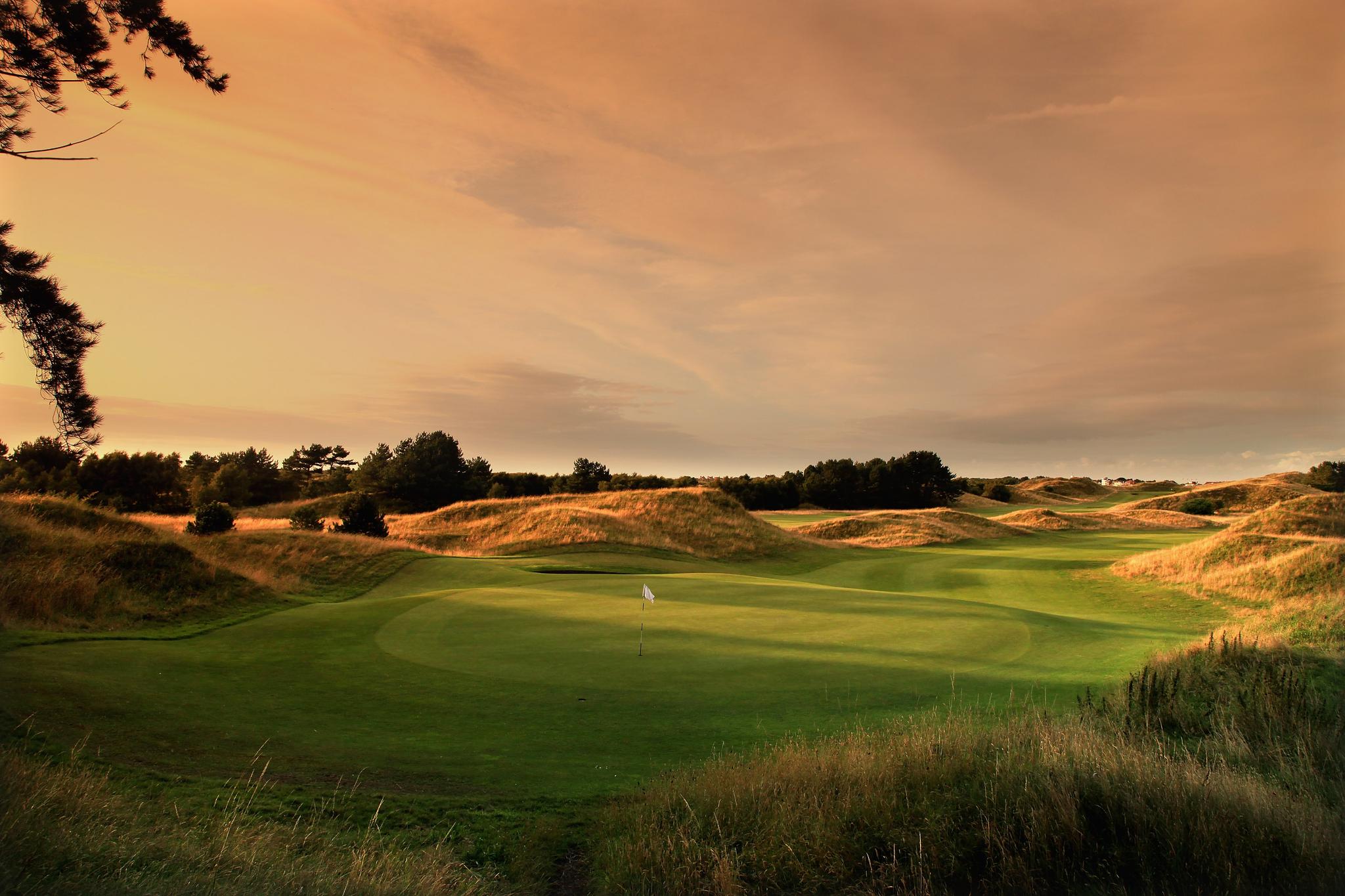 Well maintained fairway leading to a smooth green at sunset