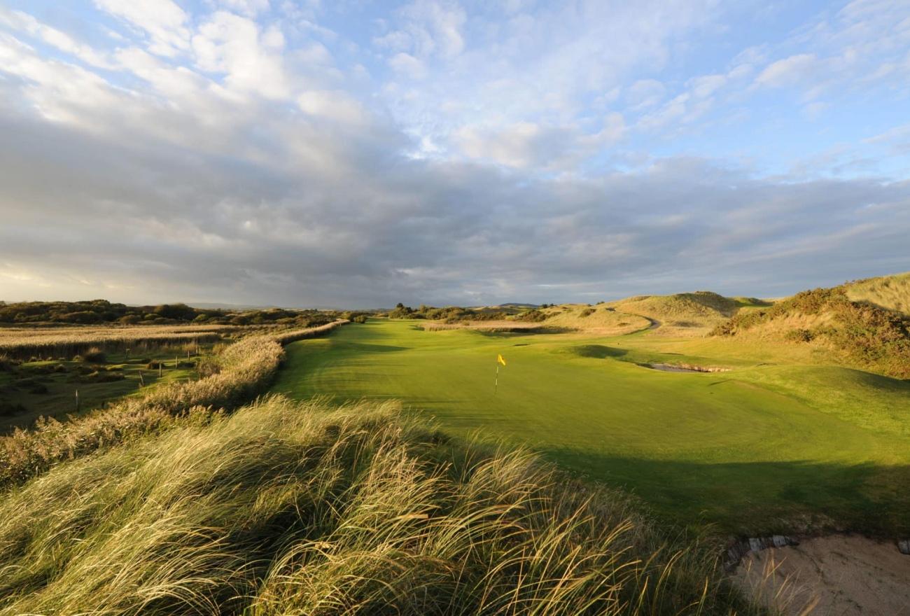 A well maintained fairway leading to a smooth green