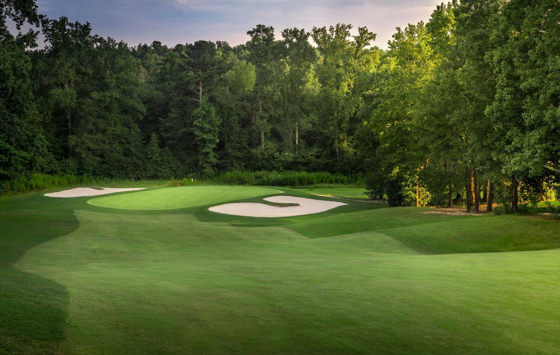 A winding fairway leading to a smooth green