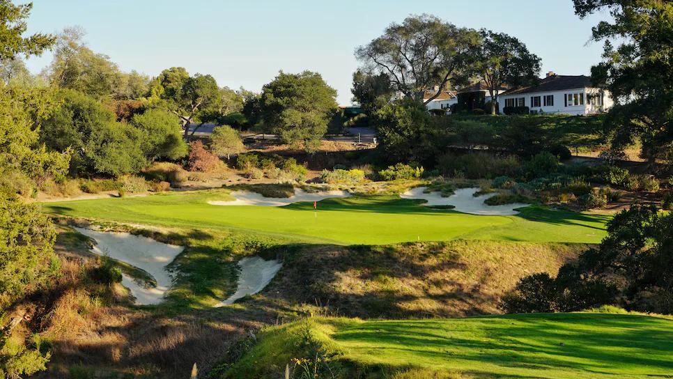 A smooth elevated green surrounded by sand bunkers