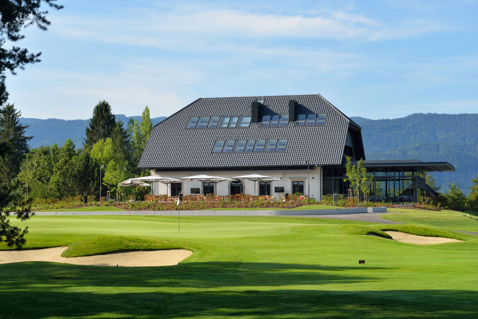 Panoramic view of the Royal Bled Golf Resort clubhouse overlooking the course