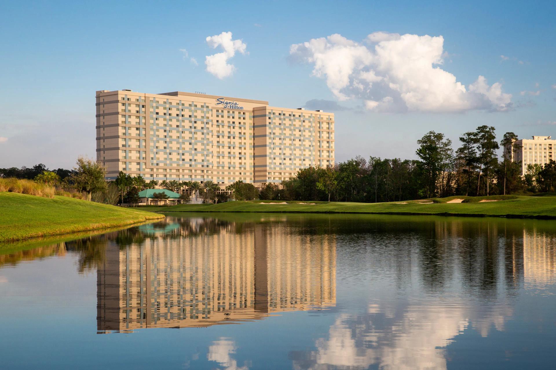 Panoramic view of the Signia by Hilton Orlando overlooking the course reflecting off a water hazard
