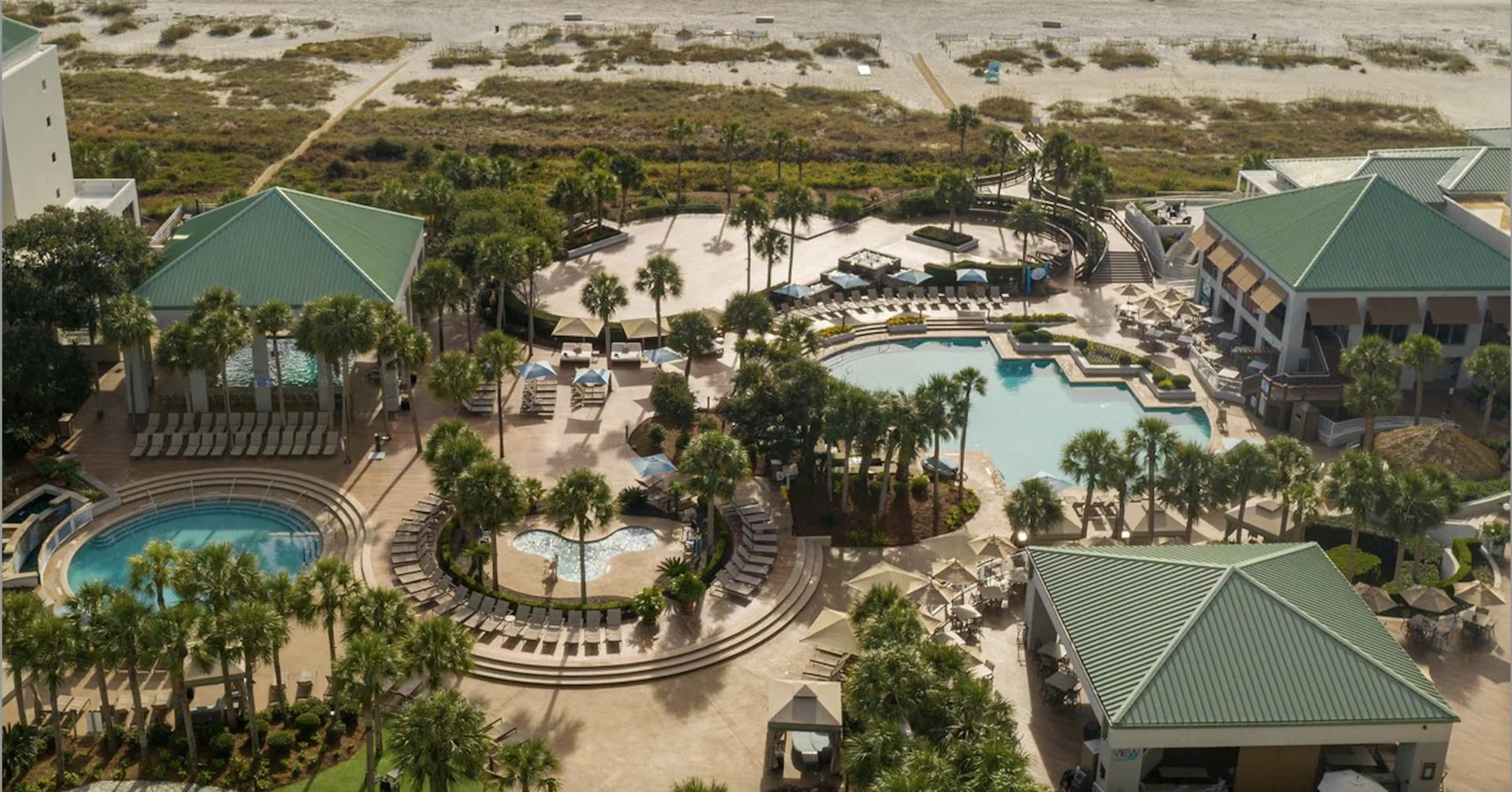 Overhead view of the outdoor swimming pool and cabanas at the resort