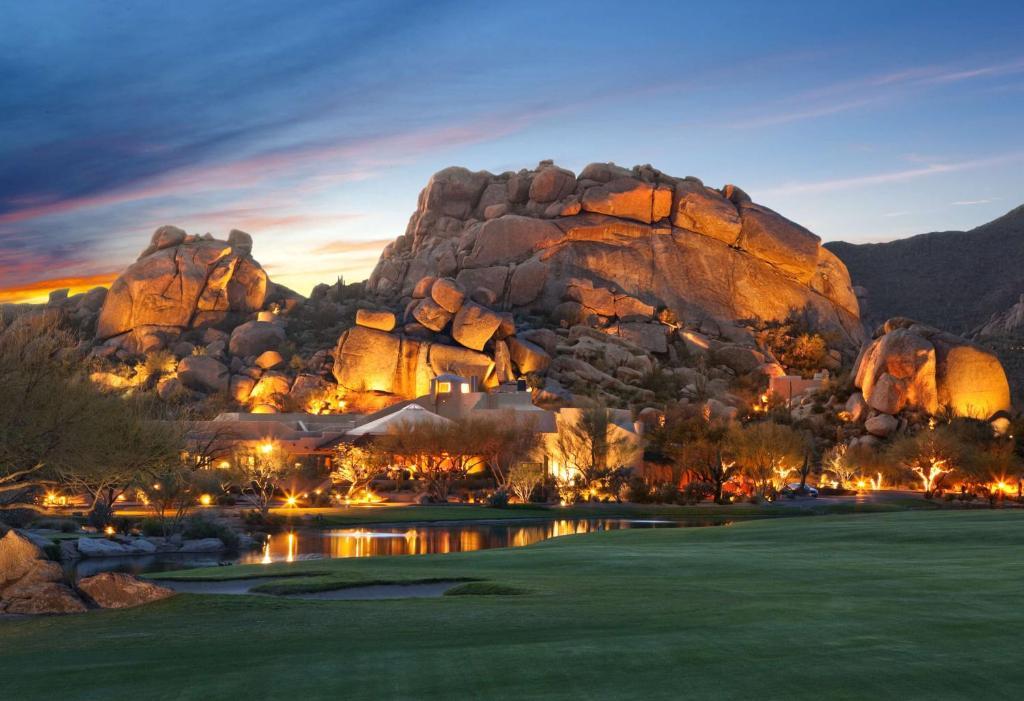 Illuminated rocks towering over the golf course at Boulders Resort & Spa