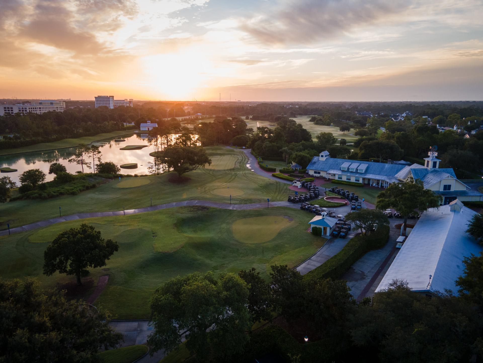 Birdseye view buggies parked at the Celebration Clubhouse overlooking the course during sun set