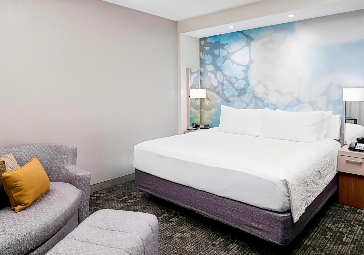 Double bed suite at the hotel following a simple design with a sofa for lounging