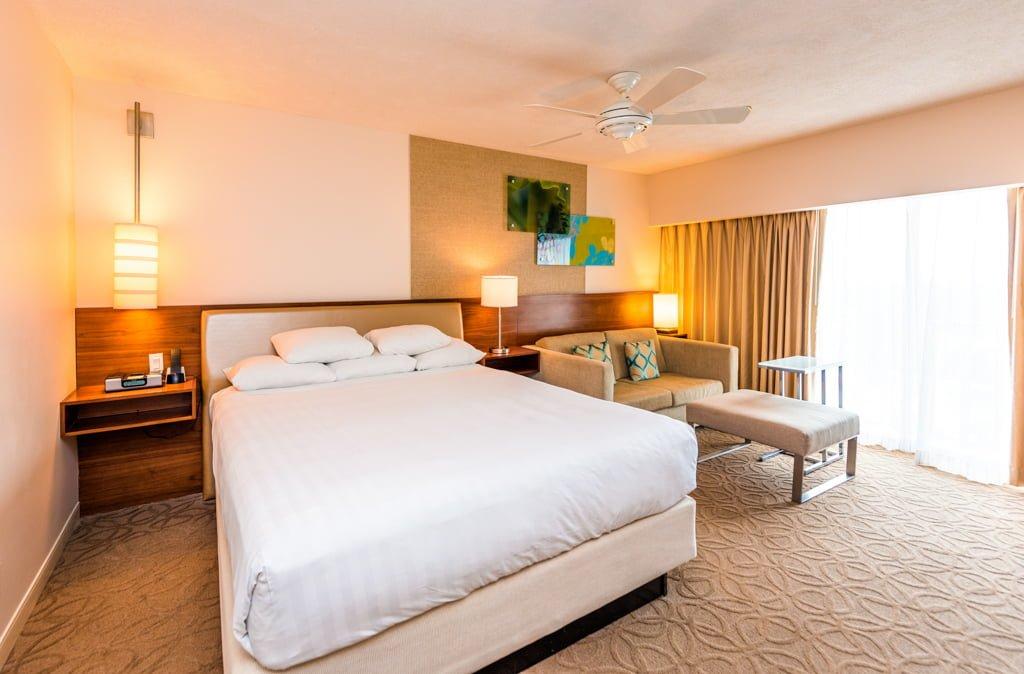 Double bed suite at the hotel with panoramic window and sofa area for lounging