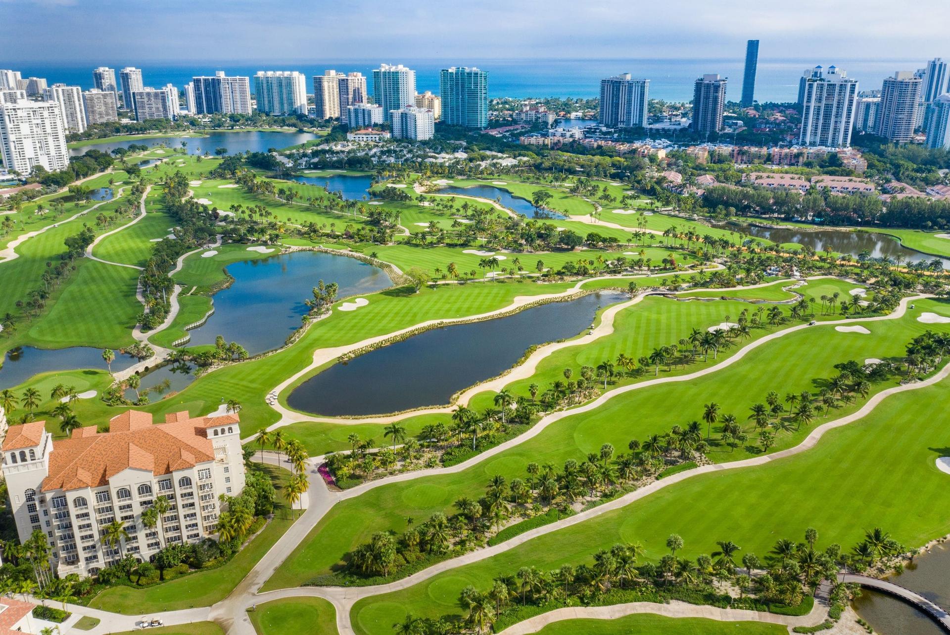 Aerial view of the long fairways at the course with city views in the distance