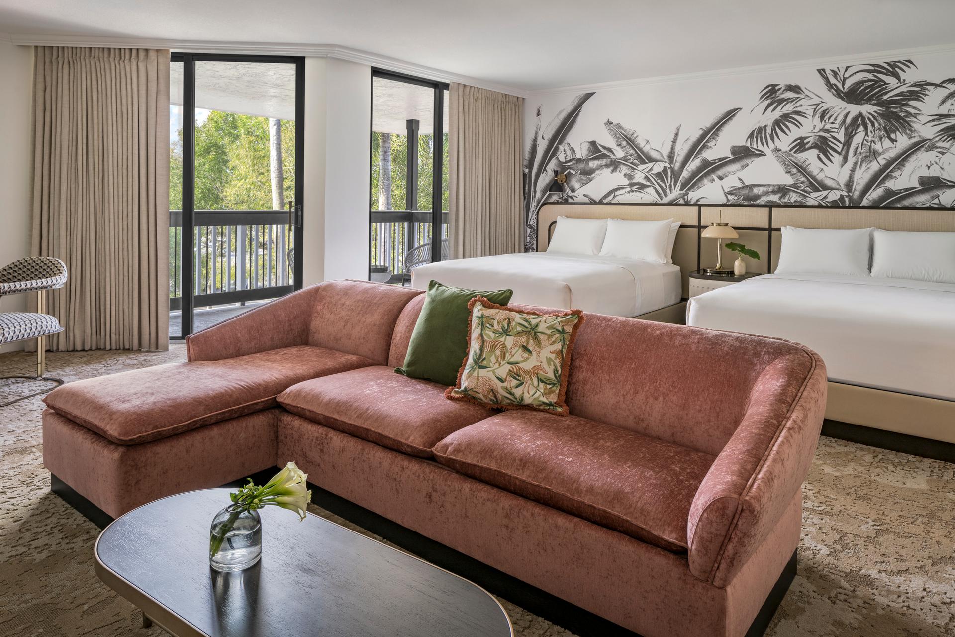 Twin double bed room at the resort a sofa for lounging and balcony views of nature