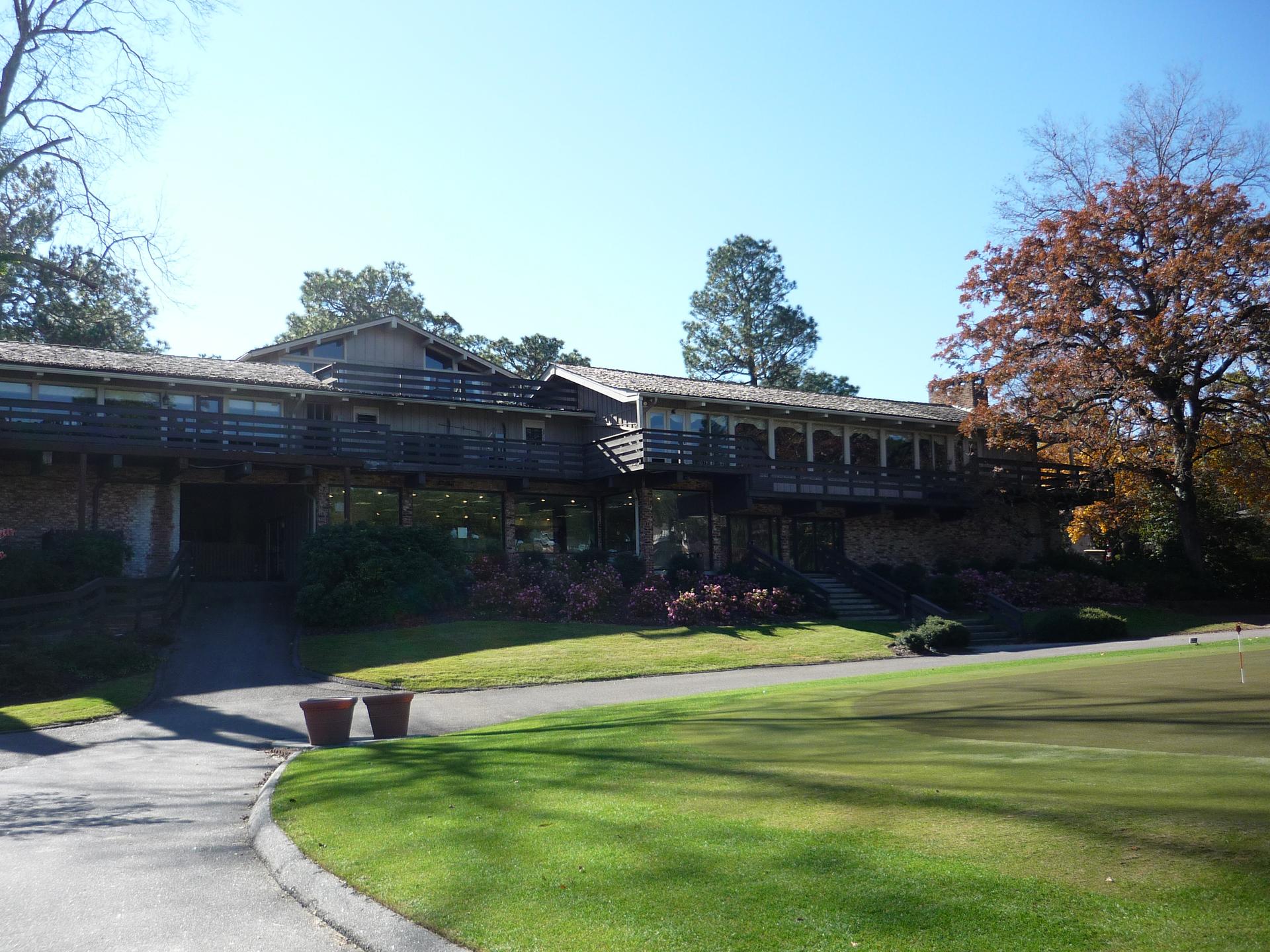 The wooden clubhouse building elevated above the course