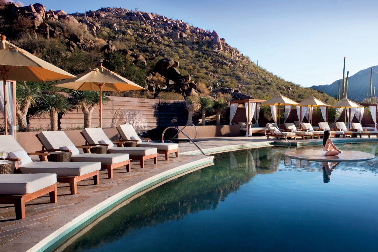 Outdoor swimming pool surrounded by sunbeds