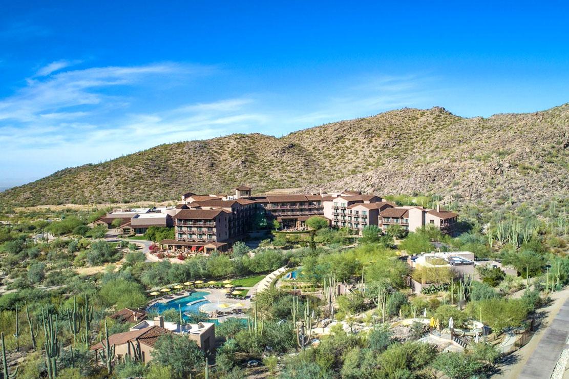 Overhead view of the resort building with a mountain towering over