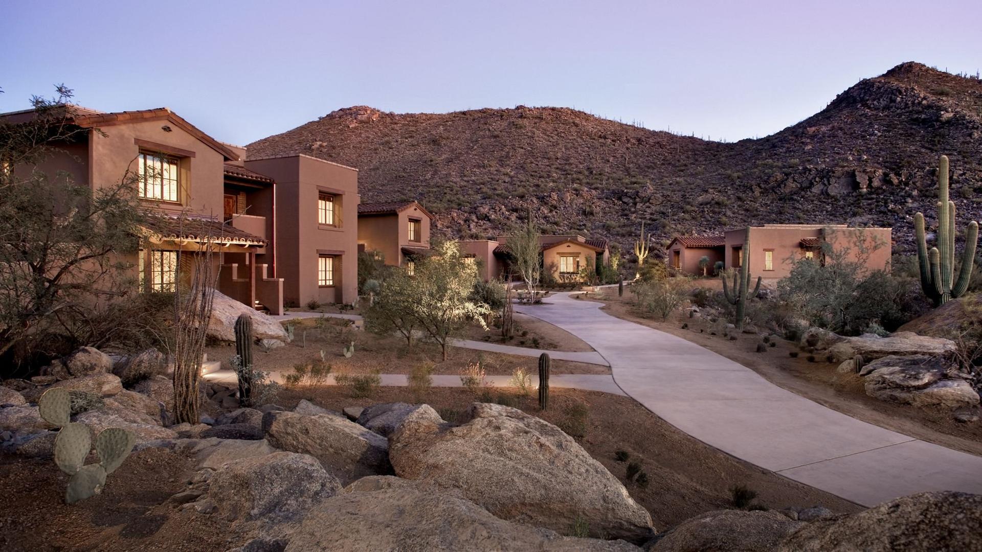 Villas in the desert with a walk path leading towards the mountains
