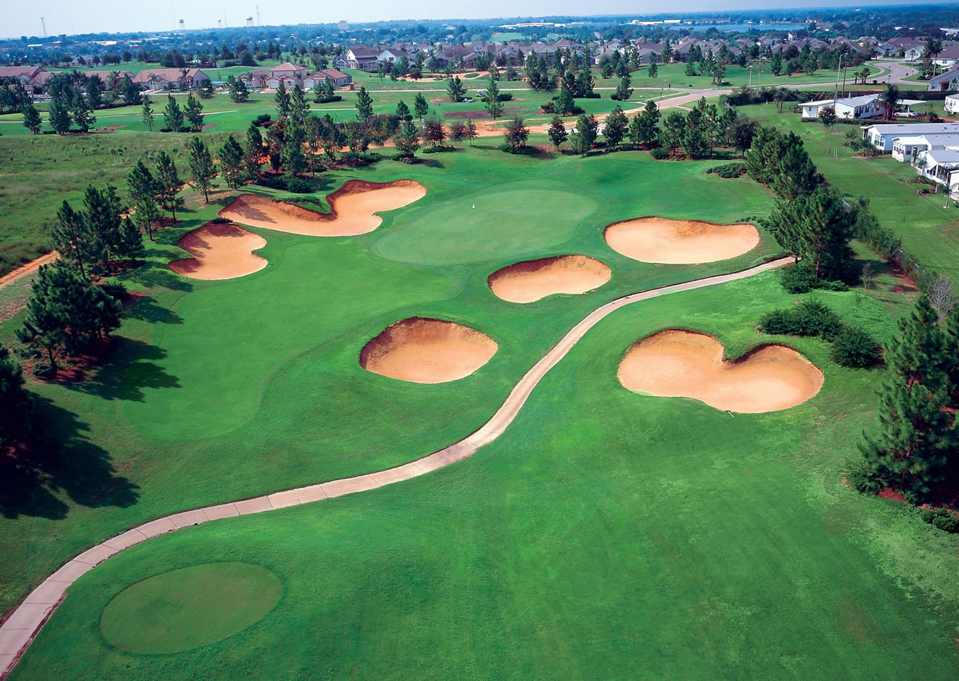 Aerial view of a Southern Dunes golf hole with multiple deep sand bunkers surrounding the green.