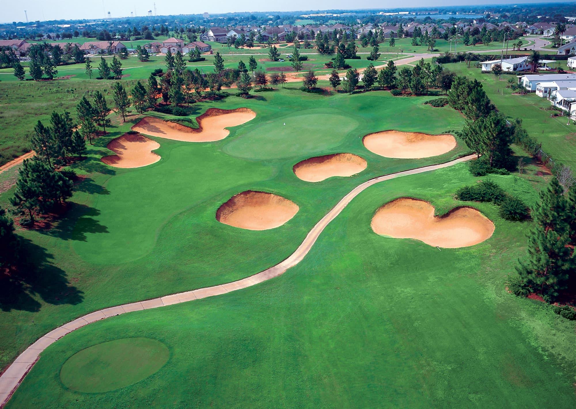 Aerial view of a Southern Dunes golf hole with multiple deep sand bunkers surrounding the green.