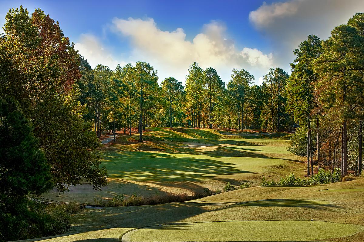 A uphill fairway with a river water hazard running through