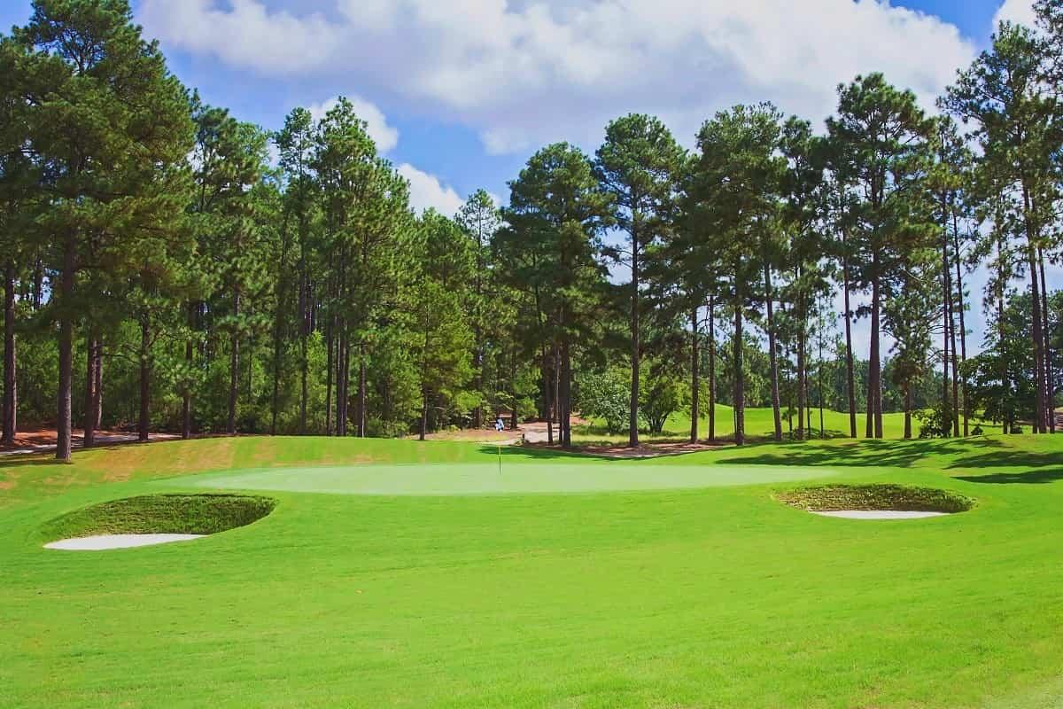 Wide fairway littered with sand bunkers