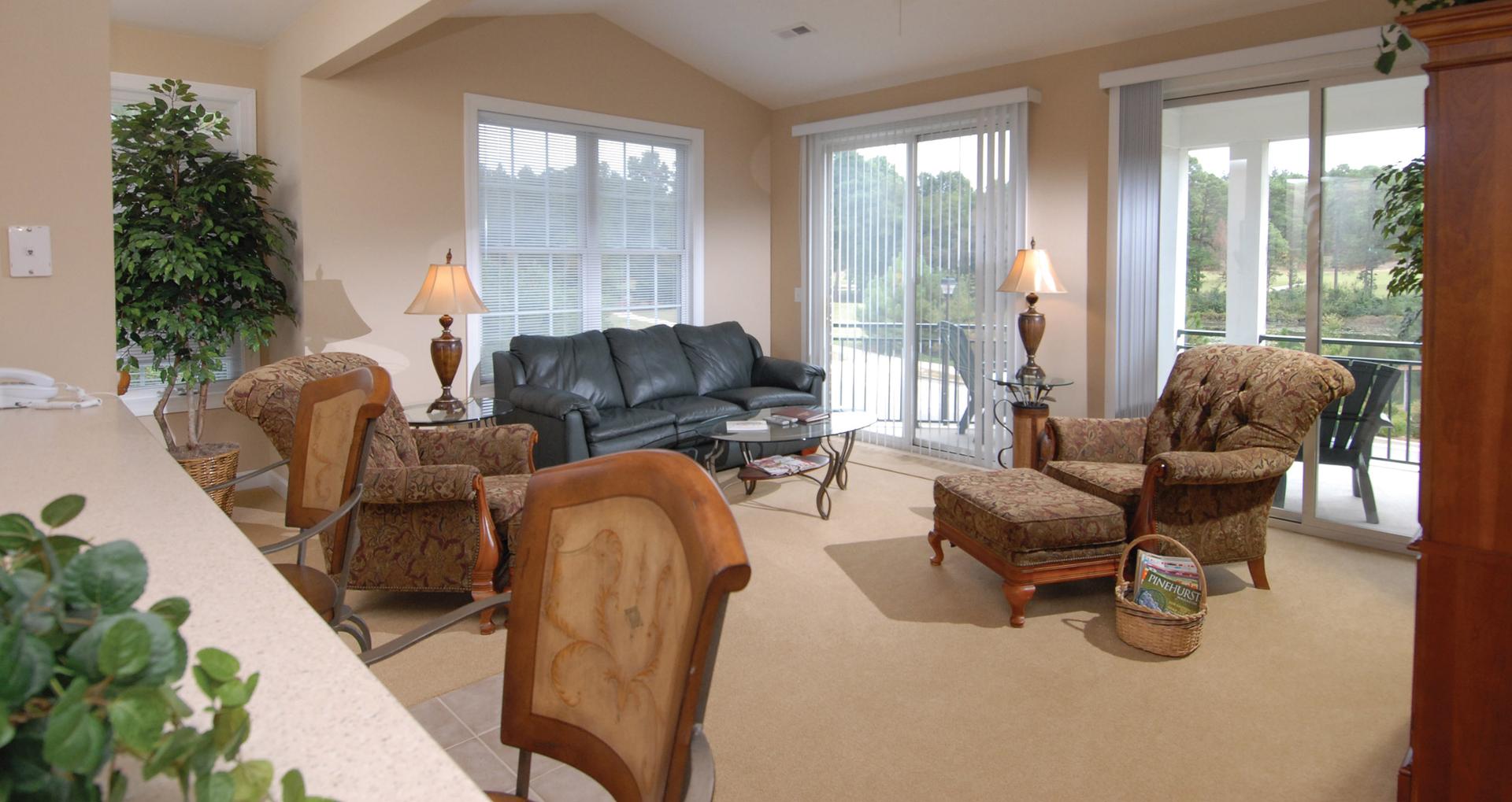 A living room as part of a villa at the resort with panoramic window views
