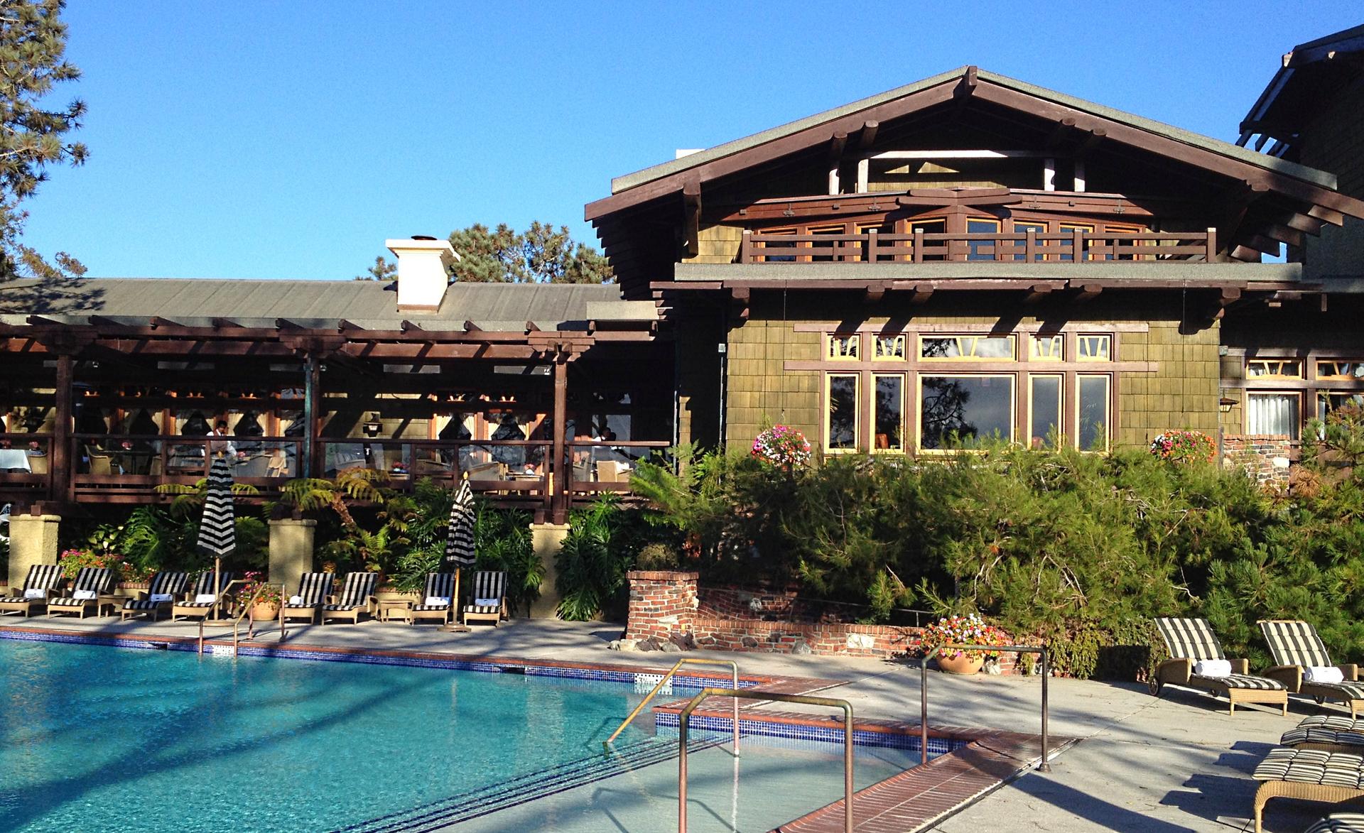 The Lodge at Torrey Pines clubhouse overlooking their outdoor swimming pool with zebra sunbeds
