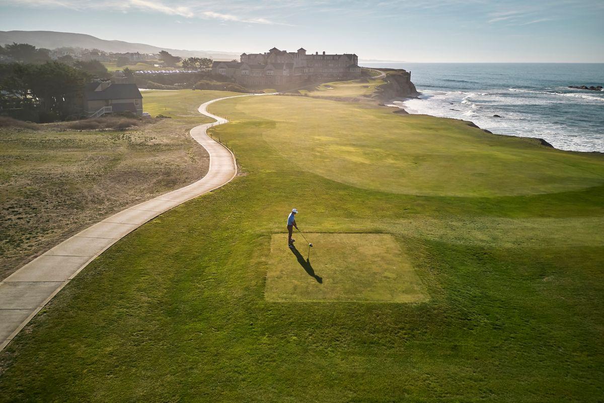 A well maintained fairway running down the coast with a walk path
