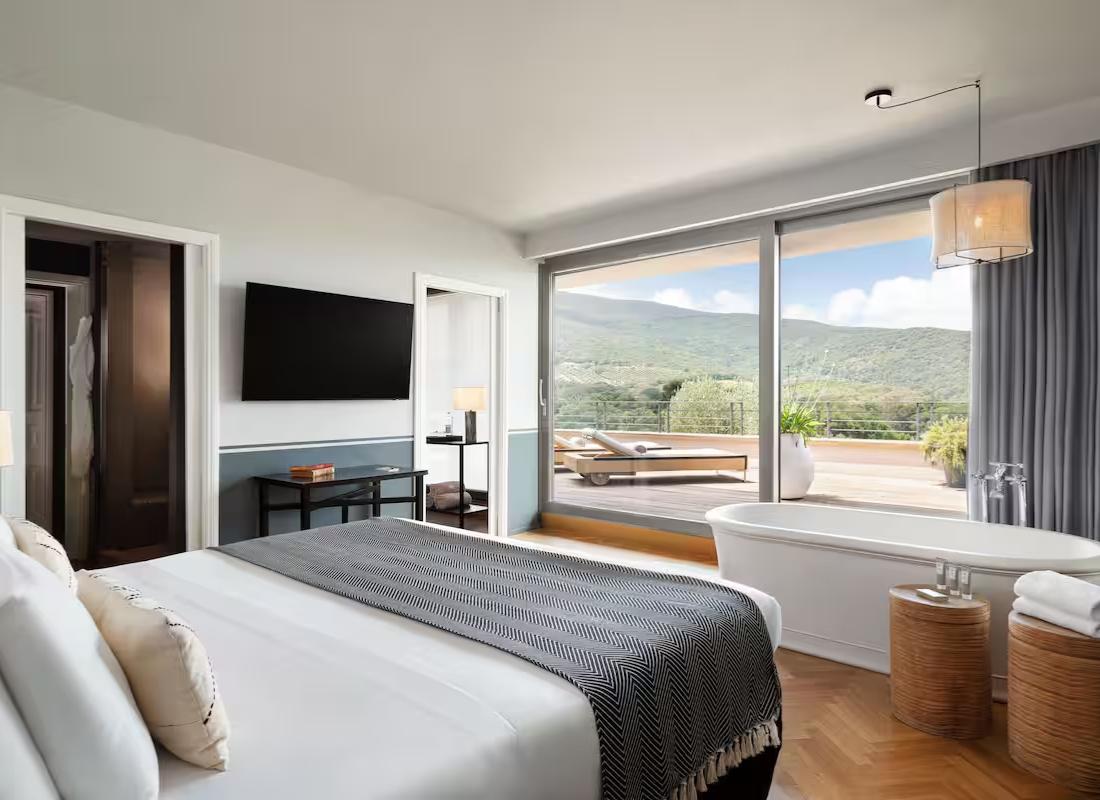 Double bed suite at the resort featuring a patio area with sun beds