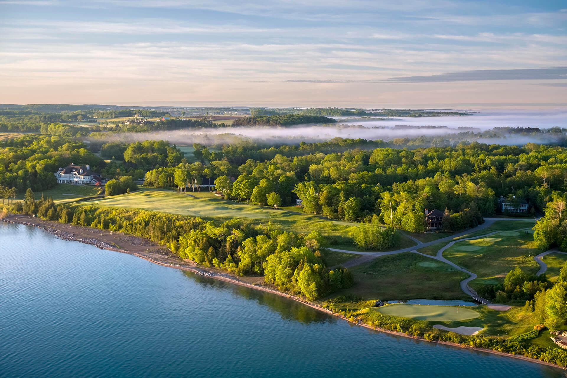 Misty morning over a lakeside golf course nestled in northern Michigan’s natural beauty.