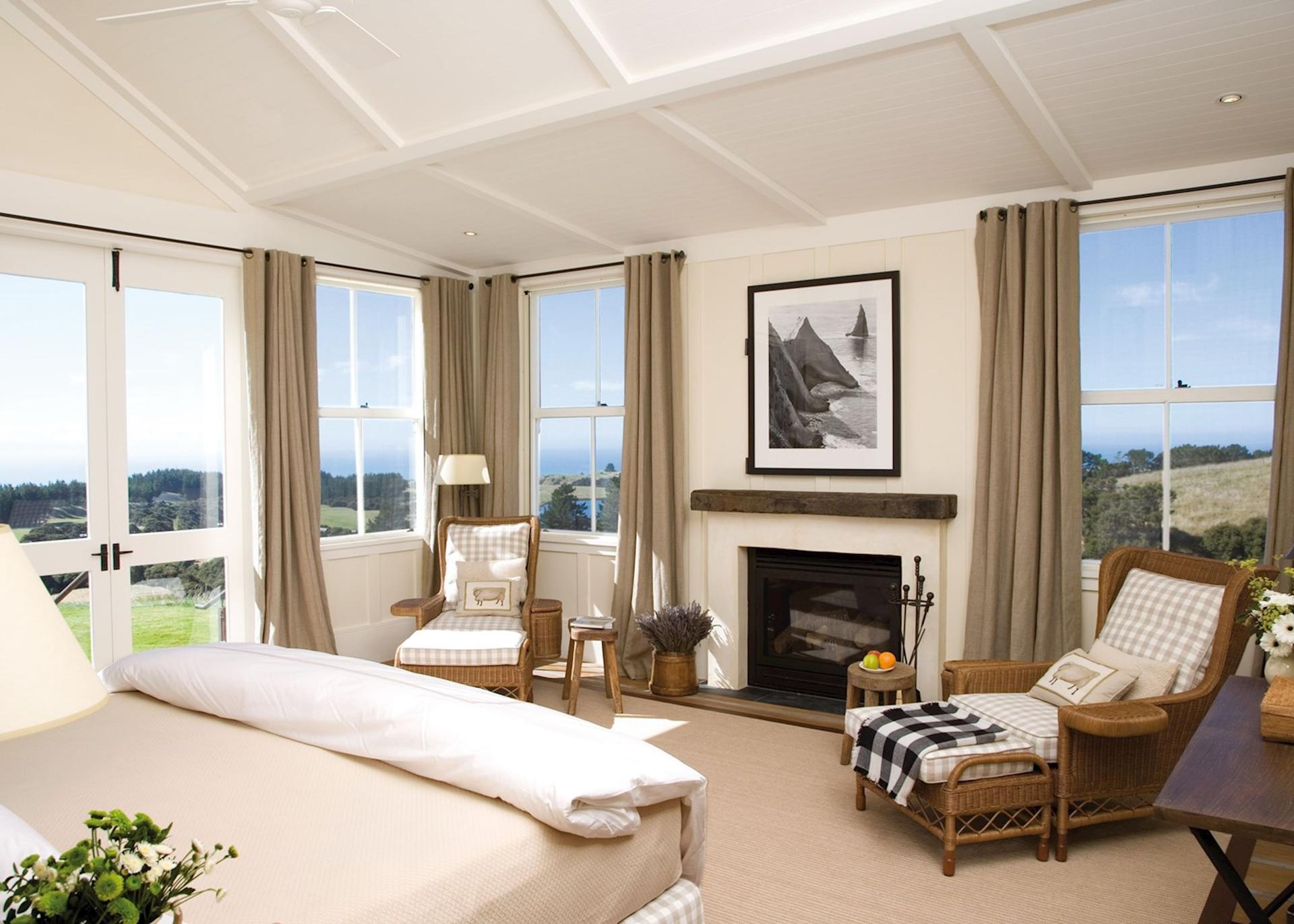 A double bed room at the Cape Kidnappers Resort with panoramic windows for views of the course