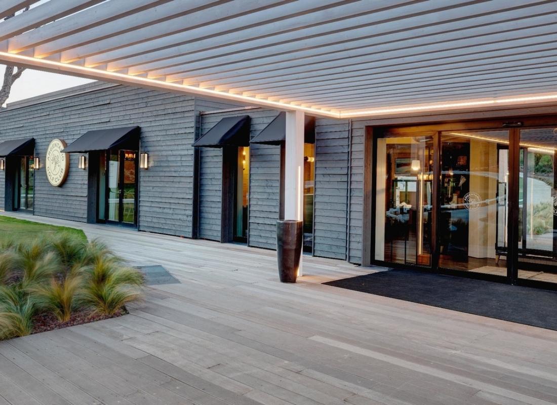 Front entrance to the Argentario Golf & Wellness Resort with their logo nestled into the wall