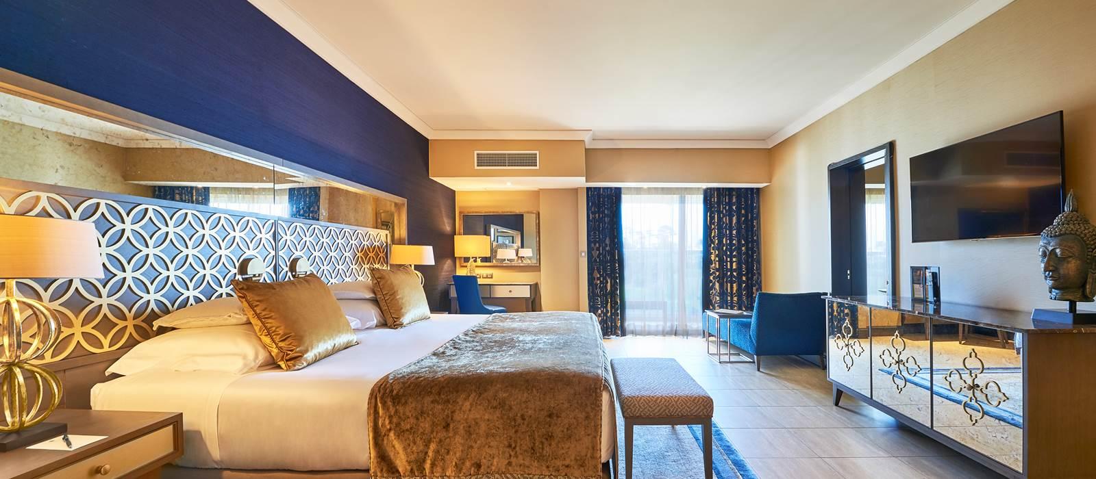 Double bed with a television and balcony