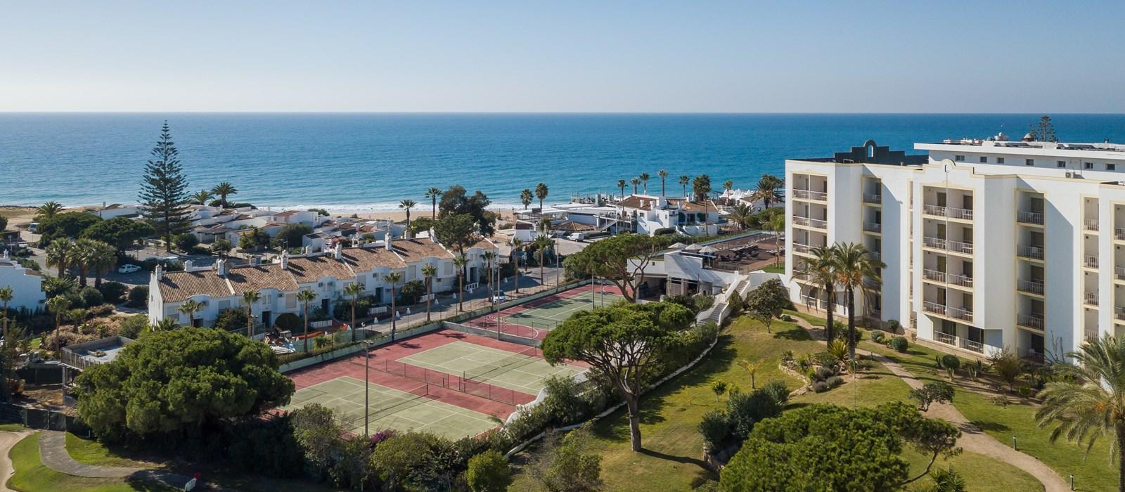 Aerial view of the hotel including the tennis courts and beach in the back ground