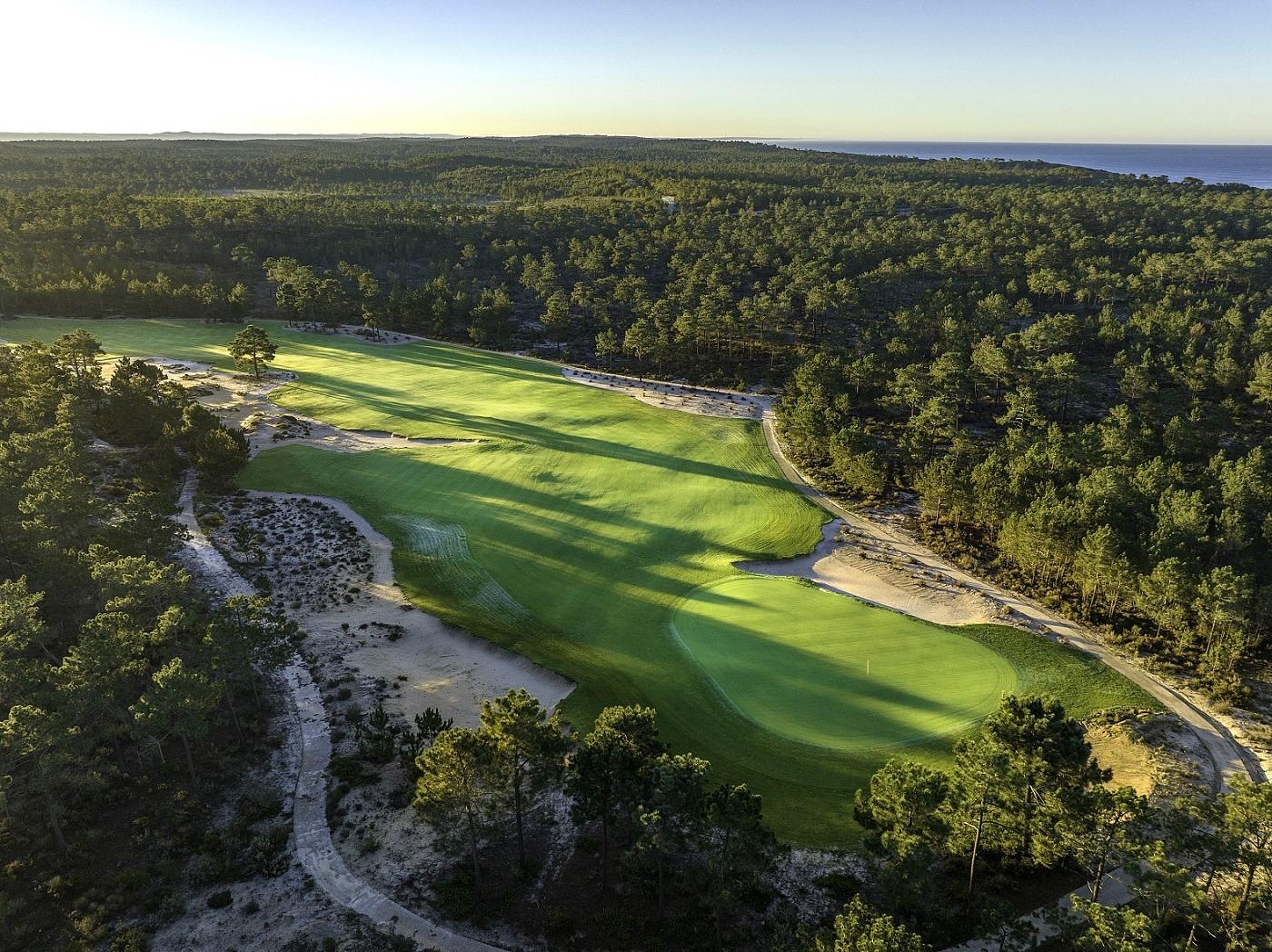 Pristine, tree-lined fairway leading to the green with bunkers on either side
