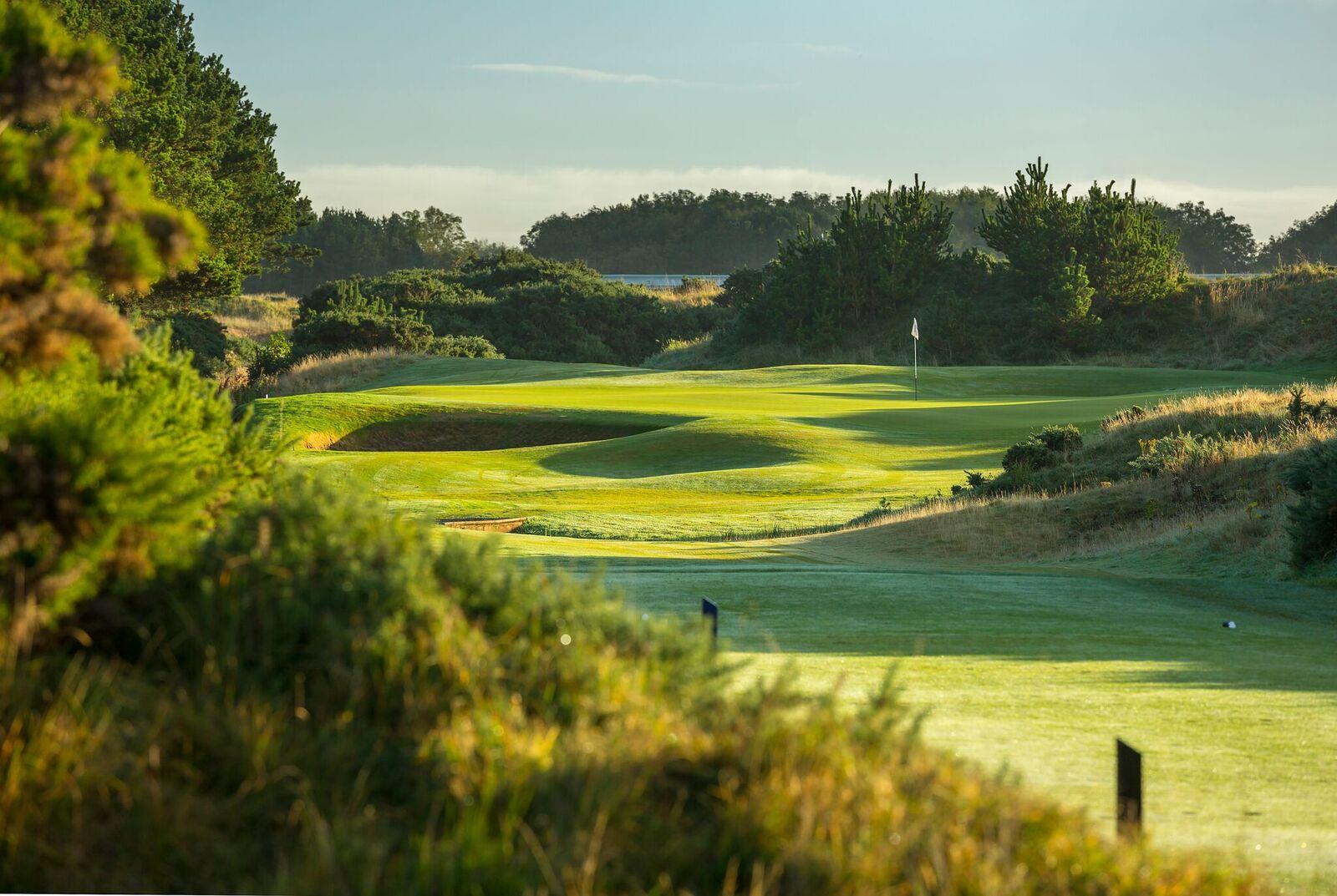 Rolling dunes at the Dondonald Links course with a deep sand bunker placed on green right next to the hole